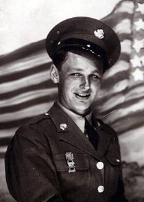 Smiling U.S. soldier in uniform with flag