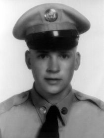 Black-and-white portrait of young soldier in uniform