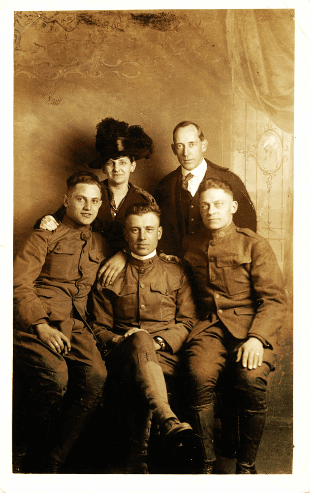 Sepia studio portrait of three soldiers and couple