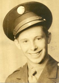 Smiling young man in vintage military uniform