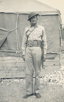 Soldier in vintage uniform outside canvas tent