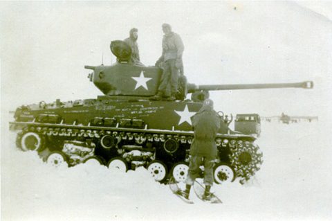 U.S. WWII tank with soldiers in snow